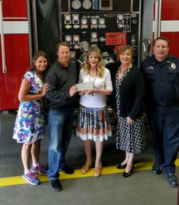 Evergreen Chamber Disaster Fund presents check to Evergreen resident.